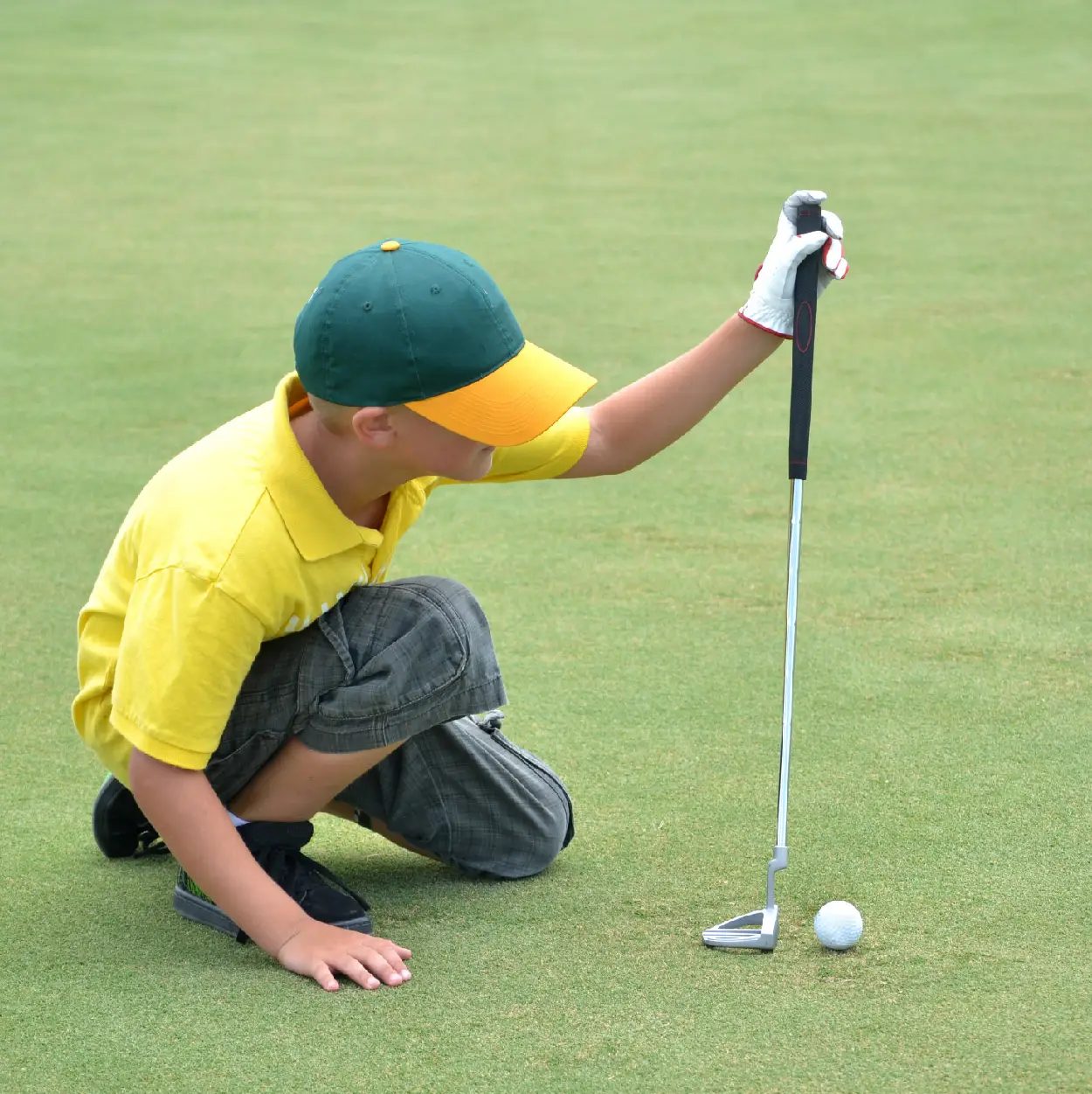 A young member lining up a putt